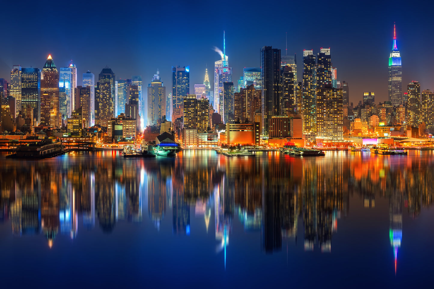 Obraz Na Płótnie Manhattan Nocą – panorama miasta w chłodnych odcieniach do wnętrz nowoczesnych i industrialnych 120x80
